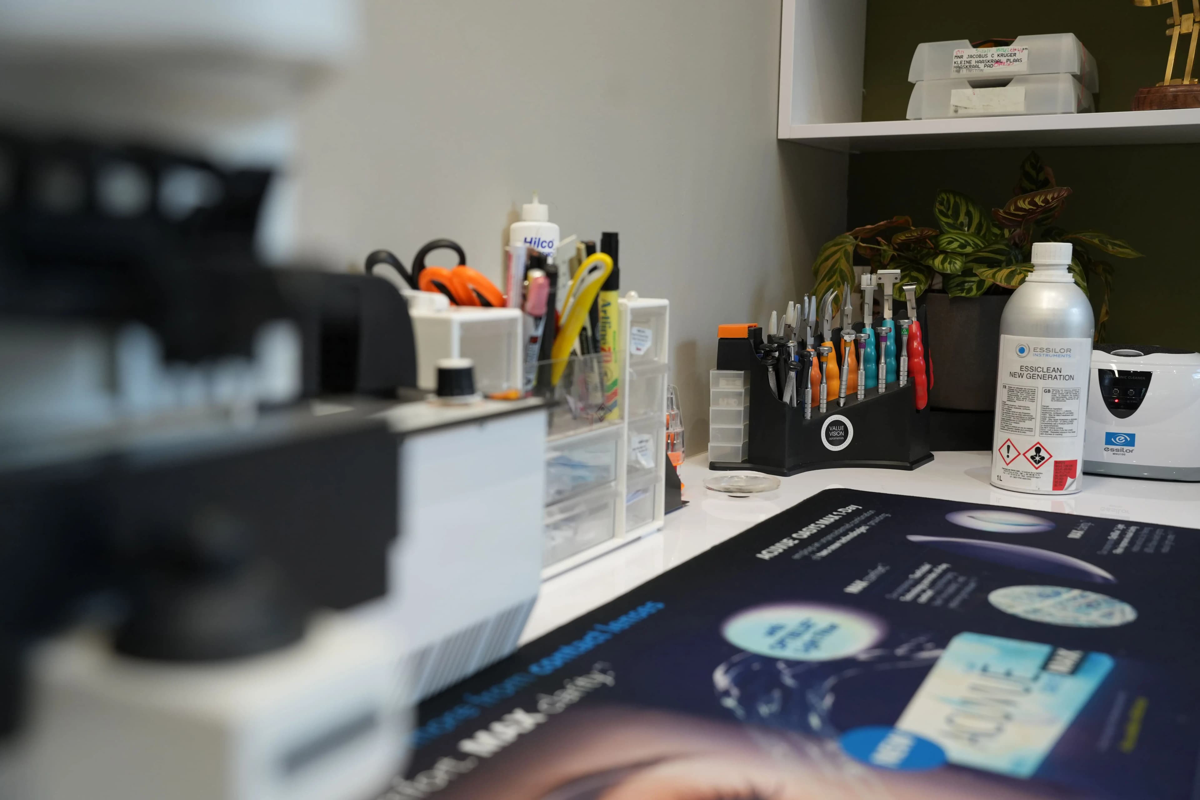 Spectacle repairs in progress on a designer frame with precision optician's tools at Reza Ferreira Boutique Optometrists