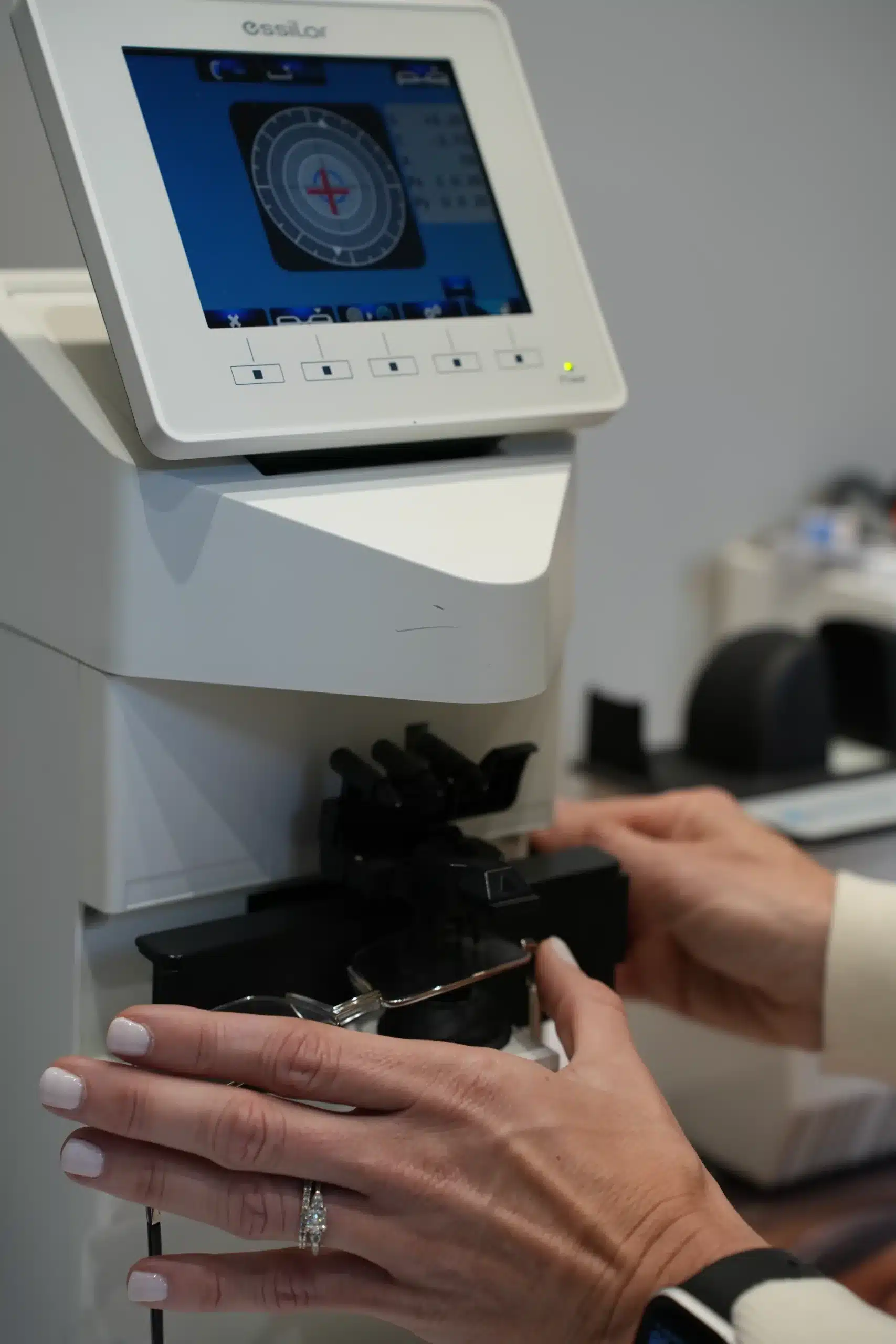 Spectacle frames being measured on an Essilor lens tracing device at Reza Ferreira Optometrist